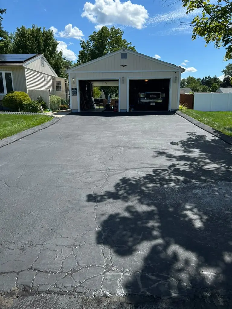 A property services contractor reviewing project plans with a homeowner outside a Ludlow, MA home